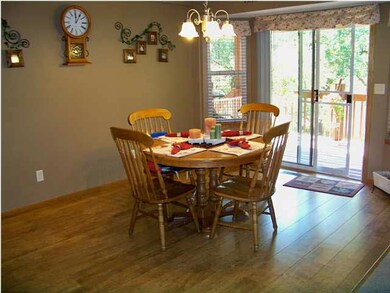 Wood floor in large dining area, bay window to cov