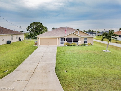 Ranch-style home with a front lawn, a garage, and