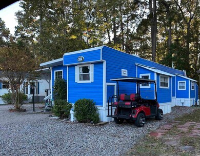 View of front of house with view of scattered trees