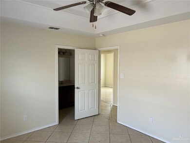 Spare room with light tile patterned floors, ceiling fan, and baseboards
