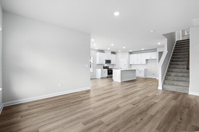 Unfurnished living room with sink and light wood-t