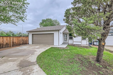 Ranch-style house featuring driveway, a shingled roof, a garage, and stucco siding