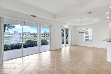 Unfurnished room featuring a tray ceiling, a notab