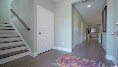 Entrance foyer featuring wood finished floors, baseboards, stairway, and recessed lighting