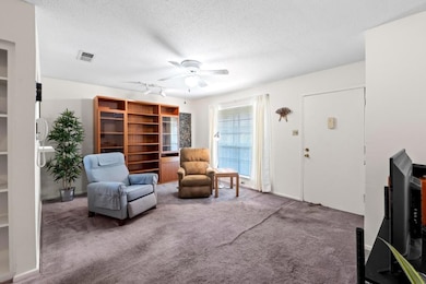 Sitting room featuring carpet flooring, a texture