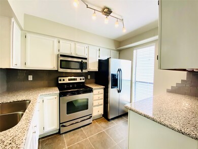The kitchen offers granite counters, stainless app