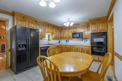 Spacious kitchen with tile flooring, plenty of cab