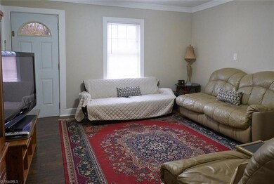 Spacious living room with laminate floors.