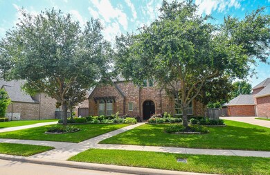 Mature trees and manicured landscaping.