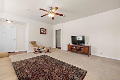 Living room with carpet floors and a ceiling fan