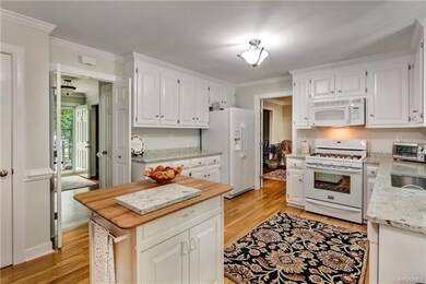 Kitchen - Wood floors, white cabinets with quartz 