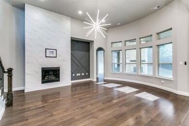 Both the custom tile fireplace and designer accent wall offer an option to place the television.  Designer light fixture brightens up the room which features plenty of natural light.