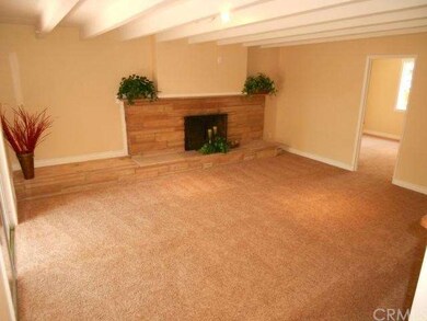 Family room off the kitchen with fireplace.