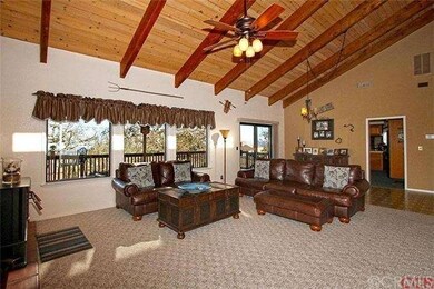 Living and Dining room with fireplace and deck acc