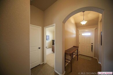 Tiled foyer with arched doorway