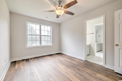 Spare room with ceiling fan and hardwood / wood-style flooring