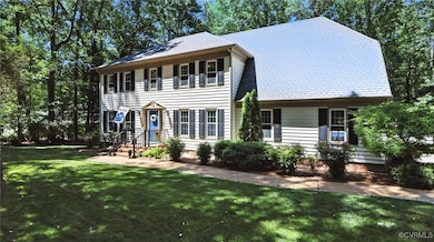 Colonial-style house featuring a front lawn