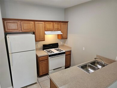 Kitchen with white appliances, under cabinet rang