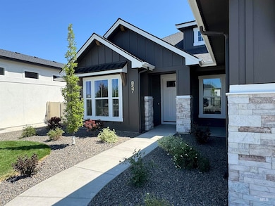 Doorway to property featuring board and batten siding and stone siding