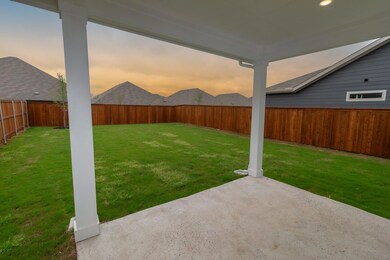 Yard at dusk featuring a patio and a fenced backya