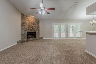 Unfurnished living room with visible vents, carpet