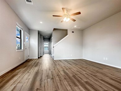 Unfurnished living room featuring wood finished f