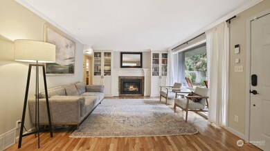 The formal living room boasts a gas fireplace surrounded by a stately mantel and built-ins adding to the focal point of the space.
