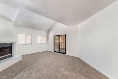 Unfurnished living room with carpet flooring, a fi