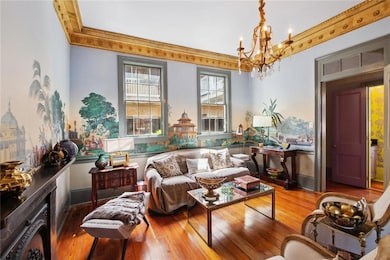 Living room/ parlor has hand painted wallpaper and