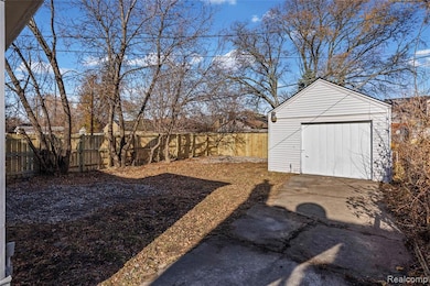 Fenced backyard with an outbuilding