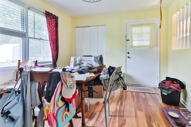 Dining space with hardwood / wood-style flooring