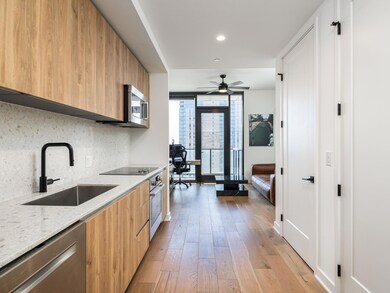 Kitchen featuring tasteful backsplash, modern cab