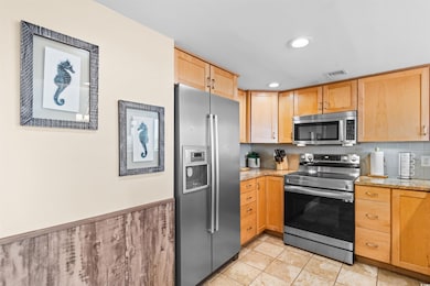 Kitchen featuring light stone counters, decorative