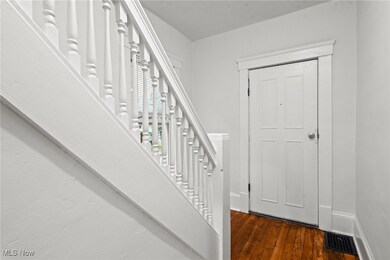 Entrance foyer with dark hardwood / wood-style flooring