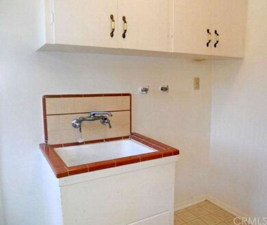 Convenient indoor laundry room with utility sink a