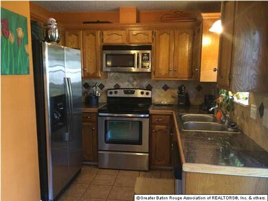 Kitchen with electric cooktop and stainless applia