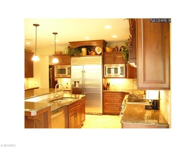 Custom kitchen featuring cherry cabinetry, granite