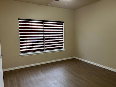 Empty room with baseboards, a textured ceiling, ce