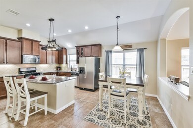 Kitchen and dining area open to family room
