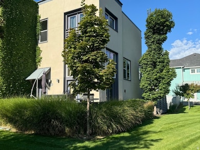 View of side of home with stucco siding and a lawn