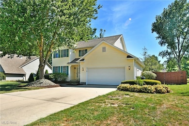 Traditional-style home with an attached garage and driveway