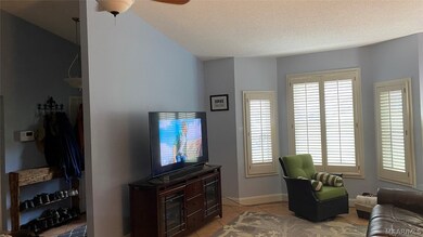 Large grand room with bay windows and plantation s