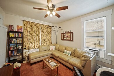 The living room has hardwood floors, ceiling fan a