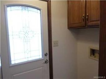 Laundry room with cabinets located off from the ki