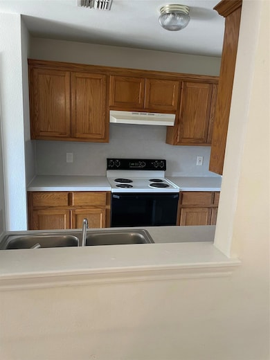 Kitchen featuring range with electric cooktop, ra
