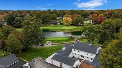 Bird's eye view of a local golf course and a nearby body of water