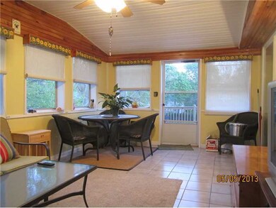 Porch. Full enclosed porched leads to deck and bac