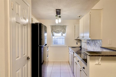Kitchen with a sink, freestanding refrigerator, d