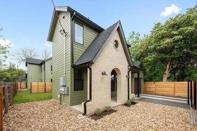 View of side of home with a fenced backyard, bric