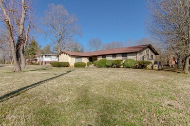 Huge front yard with lots of mature trees in this 